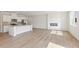 Open-concept living room and kitchen with hardwood floors, a fireplace and modern appliances at 2841 Bullfrog Ln # 175, Gainesville, GA 30115
