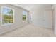 Bright bedroom with soft carpet, two windows with green views, and a white door at 2853 Bullfrog Ln # 172, Gainesville, GA 30115