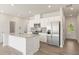 Modern kitchen featuring stainless steel appliances, a granite island, and a stainless refrigerator at 2853 Bullfrog Ln # 172, Gainesville, GA 30115