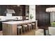 Modern kitchen with a large island, stainless steel appliances, and dark wood cabinets at 3010 Florence St, Cumming, GA 30041