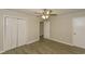 Neutral bedroom with laminate flooring, ceiling fan, and closet space at 4631 Ben Hill Rd, Douglasville, GA 30134