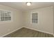 Bedroom with neutral walls, wood-look flooring and windows, creating a cozy and inviting space at 4631 Ben Hill Rd, Douglasville, GA 30134