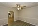 View of the dining room leading into the kitchen, complete with laminate floors and modern lighting at 4631 Ben Hill Rd, Douglasville, GA 30134