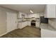 Well-lit kitchen with granite countertops, stainless steel appliances, and sleek laminate flooring at 4631 Ben Hill Rd, Douglasville, GA 30134