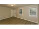 Bright living room featuring laminate flooring, a window with blinds, and a neutral color palette at 4631 Ben Hill Rd, Douglasville, GA 30134