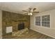 Comfortable living room with a stone fireplace, laminate flooring, and natural light from the window at 4631 Ben Hill Rd, Douglasville, GA 30134