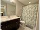 Bathroom featuring a vanity with dark wood cabinets and a shower/tub combo at 2145 Coventry Dr, Brookhaven, GA 30319