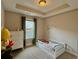 Bedroom with tray ceilings, a custom name decoration and neutral color scheme at 2145 Coventry Dr, Brookhaven, GA 30319