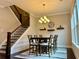 A dining room boasts a large dining table with six chairs and an elegant chandelier above at 2145 Coventry Dr, Brookhaven, GA 30319