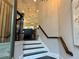 Bright entryway with stairs leading to the main living area and modern lighting fixtures at 2145 Coventry Dr, Brookhaven, GA 30319