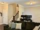 View of a living room with staircase, large comfy sofa, and computer setup at 2145 Coventry Dr, Brookhaven, GA 30319