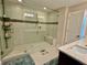 A large walk-in shower featuring tile walls, a glass door, and a built-in bench at 2145 Coventry Dr, Brookhaven, GA 30319