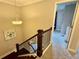 A staircase with dark wood banister, carpeted steps, and a view of the upstairs area at 2145 Coventry Dr, Brookhaven, GA 30319
