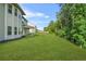 Expansive backyard boasts lush green lawn and mature trees, creating a private and serene outdoor space at 361 Traditions Ln, Hampton, GA 30228