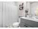 Charming bathroom featuring stylish decor, a decorative shower curtain, and a granite countertop at 361 Traditions Ln, Hampton, GA 30228