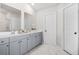 Bright bathroom featuring a double vanity, modern fixtures, and stylish marble flooring at 361 Traditions Ln, Hampton, GA 30228