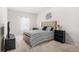 Cozy bedroom with neutral tones, comfortable bed, and modern decor at 361 Traditions Ln, Hampton, GA 30228