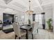 Dining room with coffered ceiling, modern chandelier, and ample natural light at 361 Traditions Ln, Hampton, GA 30228