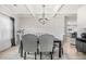 Cozy dining area with wood floors, coffered ceilings, and modern chandelier at 361 Traditions Ln, Hampton, GA 30228