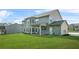 Exterior home photo reveals a large backyard and patio, perfect for outdoor activities and leisure at 361 Traditions Ln, Hampton, GA 30228
