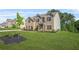 Beautiful, two-story brick home with green lawn and professional landscaping at 361 Traditions Ln, Hampton, GA 30228