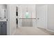 Upstairs hallway with neutral carpet, white walls, and decorative railing, offering a view of the home at 361 Traditions Ln, Hampton, GA 30228