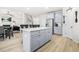 Bright kitchen features a gray island, stainless steel appliances, and a pantry for ample storage at 361 Traditions Ln, Hampton, GA 30228
