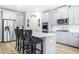 Stylish kitchen featuring stainless steel appliances, gray cabinets, and a center island at 361 Traditions Ln, Hampton, GA 30228