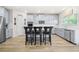 Bright kitchen with stainless steel appliances, white countertops, and island seating at 361 Traditions Ln, Hampton, GA 30228