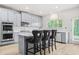 Open kitchen with an island, stainless appliances, gray cabinetry and recessed lighting at 361 Traditions Ln, Hampton, GA 30228