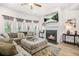 Bright living room showcasing a fireplace, mounted TV, and a comfortable seating arrangement at 361 Traditions Ln, Hampton, GA 30228