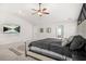 Spacious main bedroom featuring a ceiling fan, large bed, and wall-mounted television at 361 Traditions Ln, Hampton, GA 30228