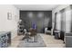 Chic home office featuring hardwood floors, modern decor, and comfortable seating at 361 Traditions Ln, Hampton, GA 30228