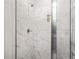 Close-up of shower with marble tiling, glass door, and modern shower head at 361 Traditions Ln, Hampton, GA 30228
