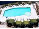 Aerial view of a sparkling blue swimming pool surrounded by lounge chairs and green foliage at 400 W Peachtree Nw St # 3412, Atlanta, GA 30308