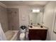Well lit bathroom featuring a tiled shower-tub, granite countertop and modern sink at 400 W Peachtree Nw St # 3412, Atlanta, GA 30308