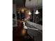 Well-designed open concept kitchen and living space featuring modern finishes and a stunning chandelier at 400 W Peachtree Nw St # 3412, Atlanta, GA 30308