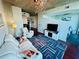 Cozy living room with an electric fireplace, plush seating, and an open view to the bedroom at 400 W Peachtree Nw St # 3412, Atlanta, GA 30308