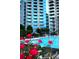 Beautiful pool with city views and flowers in the foreground, surrounded by many lounge chairs at 400 W Peachtree Nw St # 3412, Atlanta, GA 30308