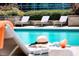 Inviting pool with lounge chairs featuring orange towels with a drink and hat on the side at 400 W Peachtree Nw St # 3412, Atlanta, GA 30308