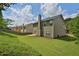 Spacious backyard with a well maintained lawn, a view of the fence and the rear of the home at 5891 Buckner Creek Dr, Mableton, GA 30126