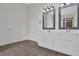Bathroom with double sinks, tile floors and modern lighting at 5891 Buckner Creek Dr, Mableton, GA 30126