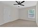 An inviting bedroom featuring a ceiling fan, a window and a door at 5891 Buckner Creek Dr, Mableton, GA 30126