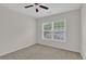 Neutral bedroom with a ceiling fan and natural light streaming through the large window at 5891 Buckner Creek Dr, Mableton, GA 30126