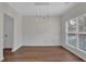 An open dining room with hardwood floors, detailed molding, and a modern pendant light fixture at 5891 Buckner Creek Dr, Mableton, GA 30126