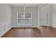 Dining area with hardwood flooring, wainscoting, and ample natural light from a large window at 5891 Buckner Creek Dr, Mableton, GA 30126