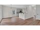 Open-concept space featuring a kitchen with gray cabinets, a breakfast bar, and hardwood floors at 5891 Buckner Creek Dr, Mableton, GA 30126