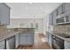 Kitchen featuring modern gray cabinets, stainless steel appliances, and a view of the dining area at 5891 Buckner Creek Dr, Mableton, GA 30126