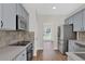 A well-lit kitchen features stainless steel appliances and sleek gray cabinets at 5891 Buckner Creek Dr, Mableton, GA 30126