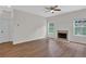 Bright living room featuring hardwood floors, a fireplace, and natural light from the windows at 5891 Buckner Creek Dr, Mableton, GA 30126
